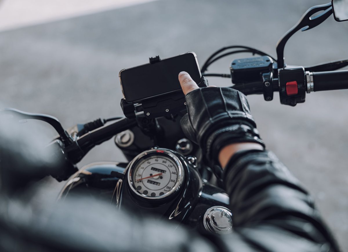 Cropped photo of motorcyclist sitting on classical motorbike outside stock photo